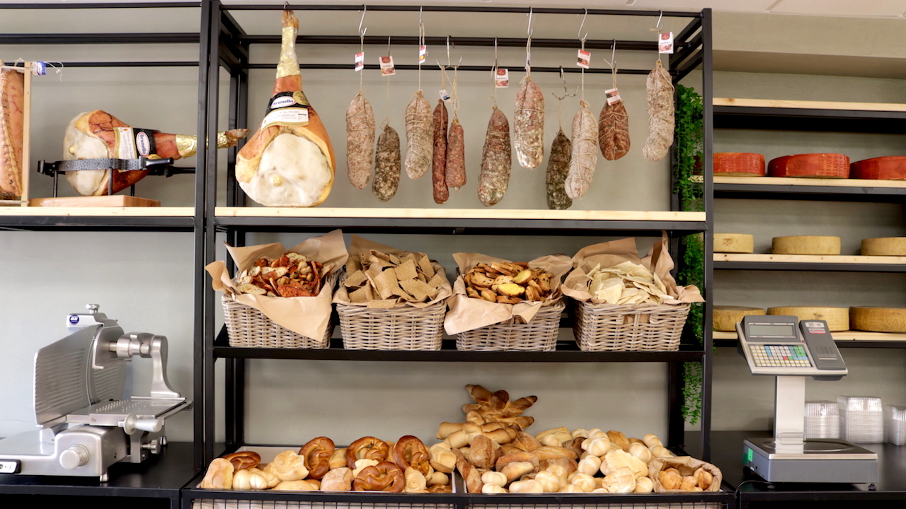 Scaffale con salumi e pane fresco